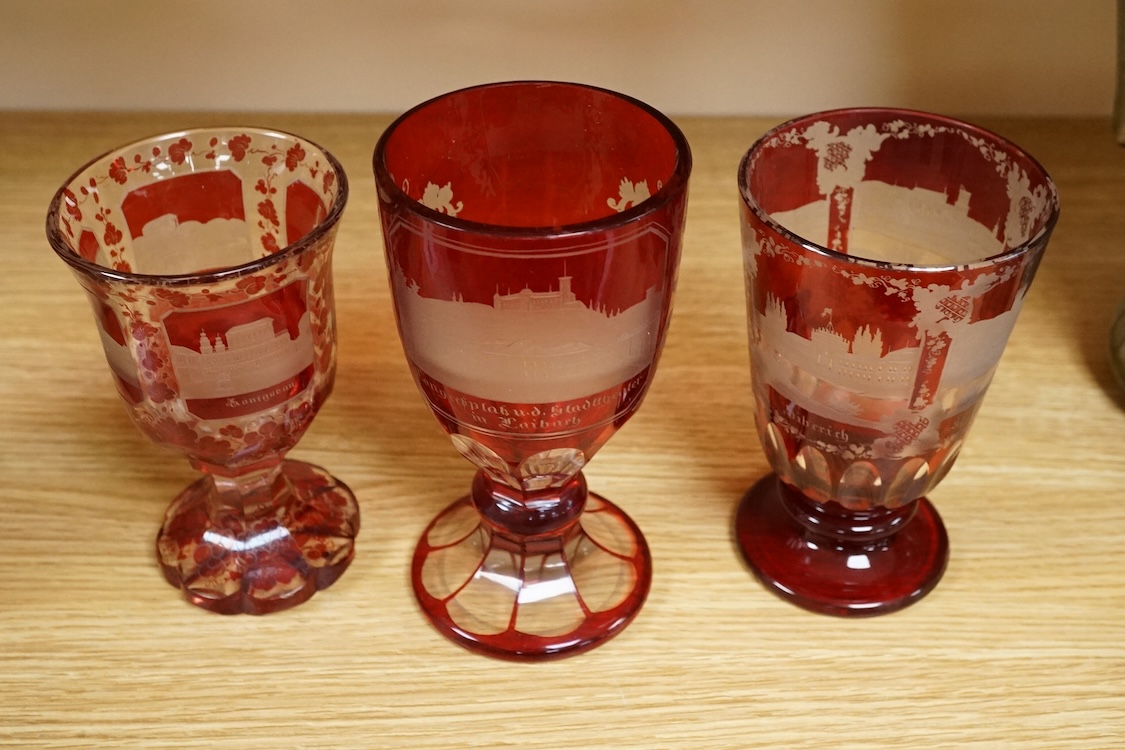 Three Bohemian topographical engraved ruby flashed spa glasses, late 19th century, largest 16cm high